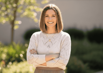 Woman with medium-length low-maintenance haircut smiling outdoors